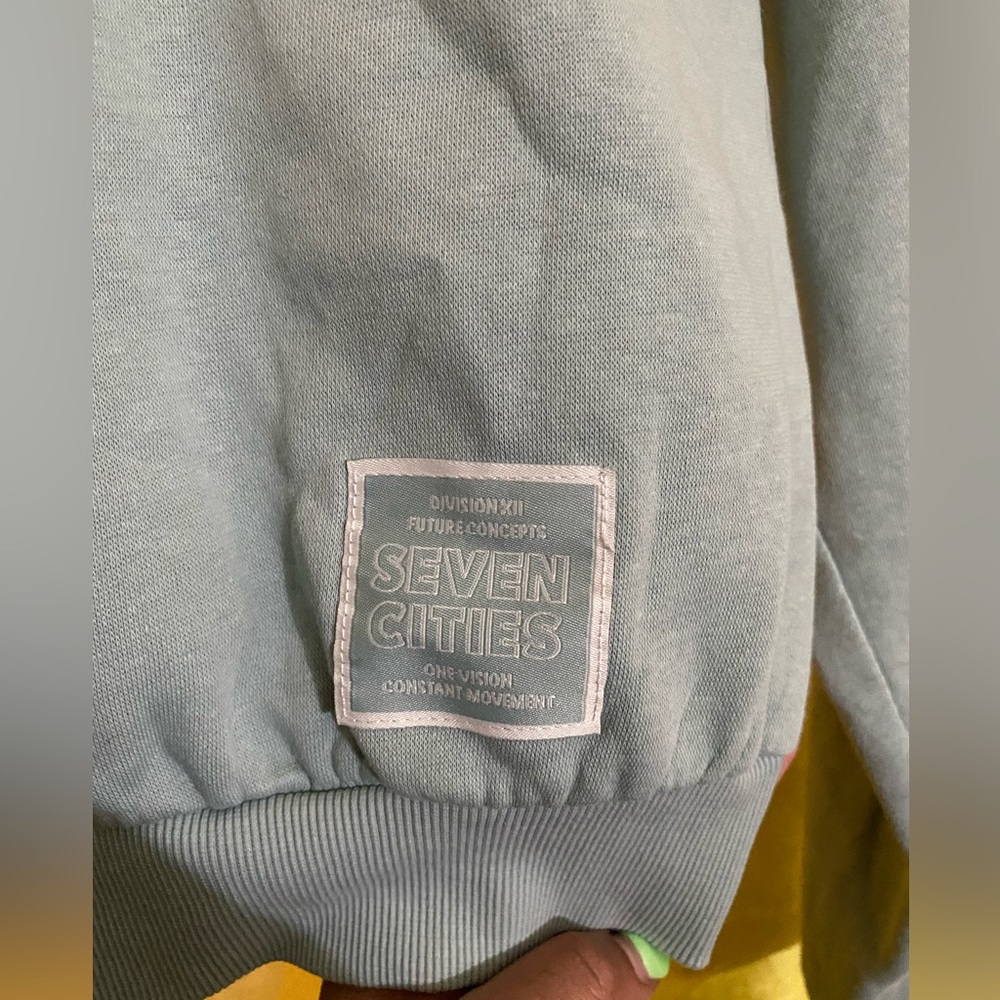 a light teal sweater